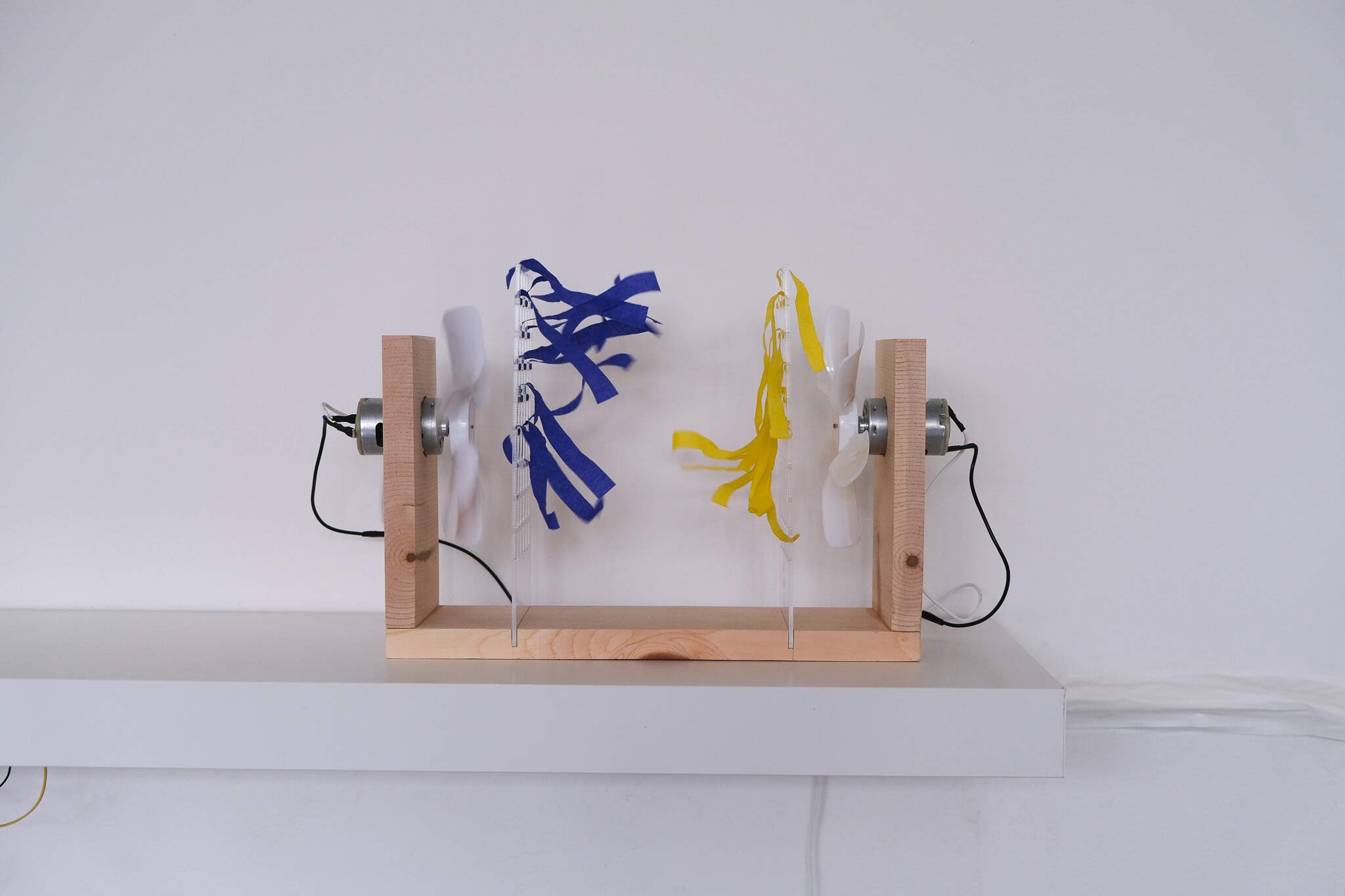 Two fans facing each other with blue and yellow streamers in Turbulent Talks