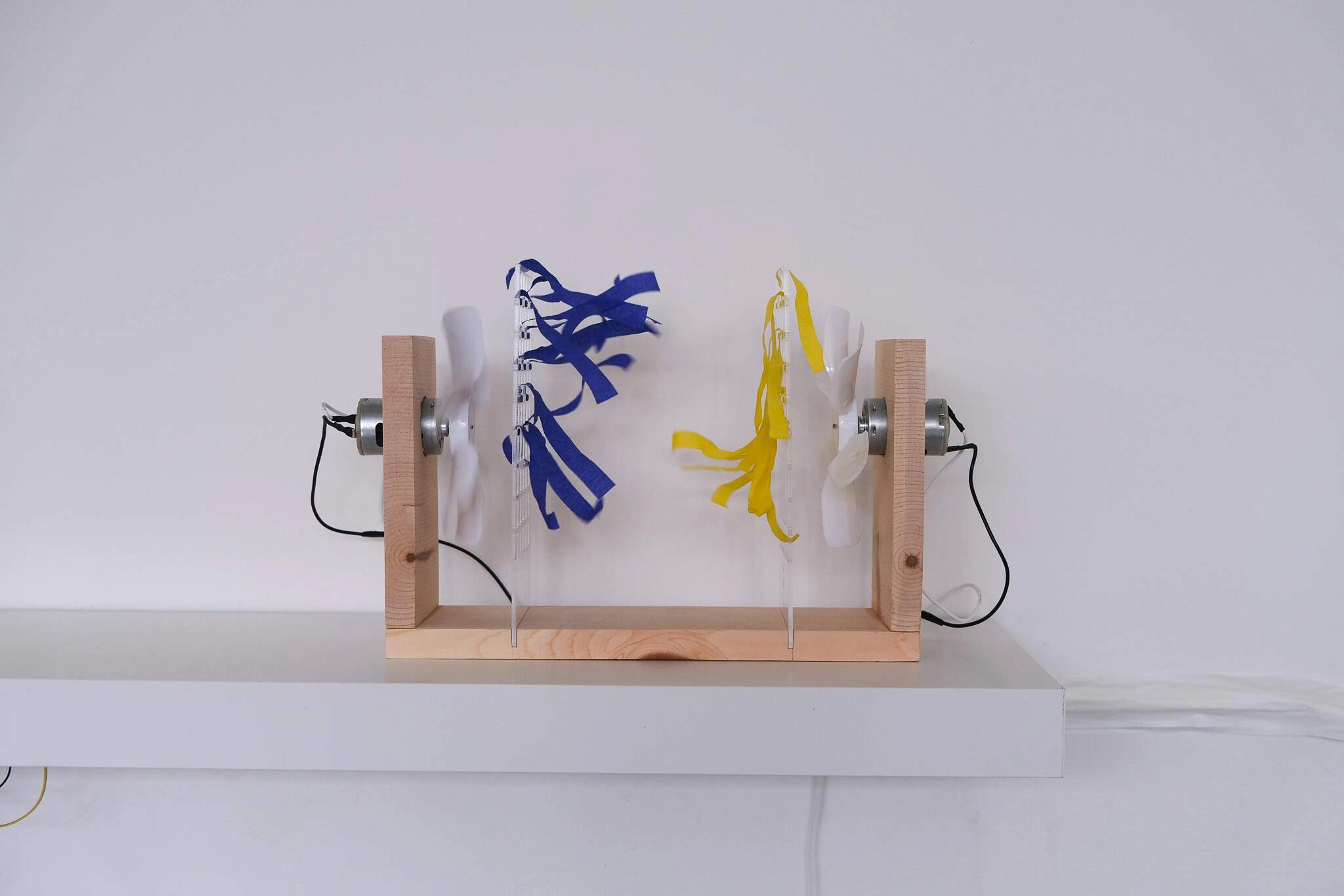 Two fans facing each other with blue and yellow streamers in Turbulent Talks